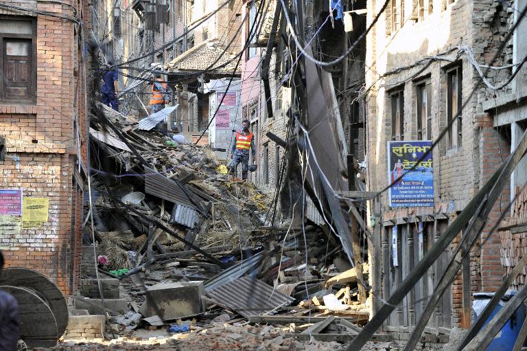 Rescuers observe damaged buildings in Bhaktapur, on the outskirts of Kathmandu, on April 27, 2015, two days after a 7.8-magnitude earthquake hit the country