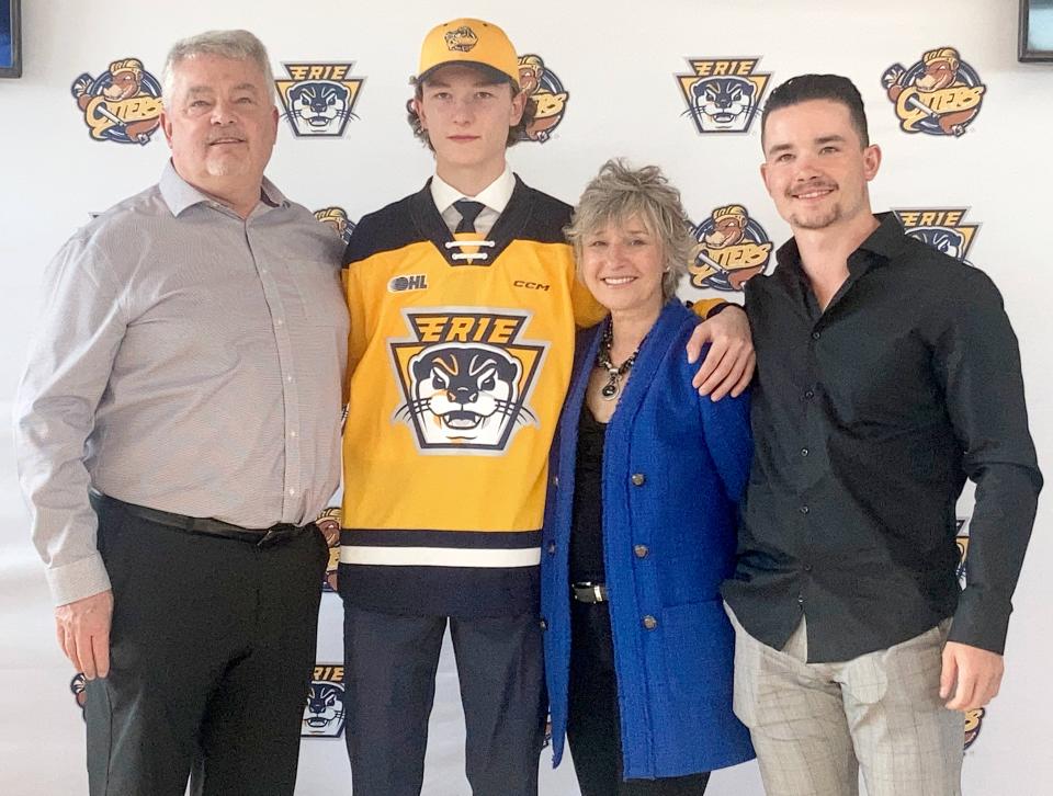Matthew Schaefer, whom the Erie Otters will choose with the No. 1 overall pick in the 2023 Ontario Hockey League priority selection draft, poses with his family during the team's April 20, 2023, event to announce his impending selection. Posing with Schaefer, a defenseman, are (left to right) his father Todd; his mother, Jennifer; and his brother, Johnny.