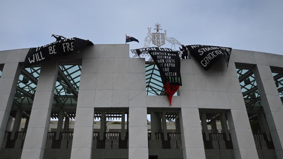 Pro-Palestine protesters unfurled banners and sent paper planes from the roof. Picture: NewsWire/ Martin Ollman
