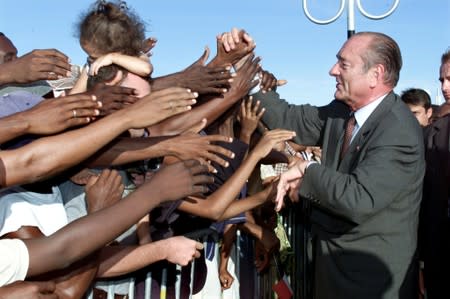 FILE PHOTO: File photo of French President Jacques Chirac sahkes hands with local residents upon his arrival at Pamandzi airport in the French overseas territory of Mayotte