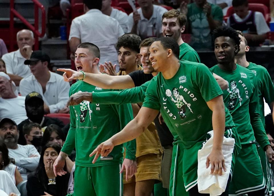 Boston Celtics players cheer the team from the bench during the second half of Game 2 of the NBA basketball Eastern Conference finals playoff series against the Miami Heat, Thursday, May 19, 2022, in Miami. (AP Photo/Lynne Sladky)