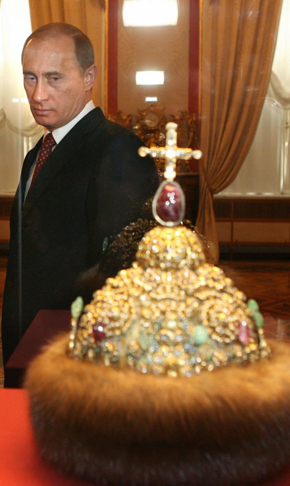 In the archival photo, Vladimir Putin looks at the crown of Peter the Great during the ceremony of the celebration of the 200th anniversary of the Kremlin Museums in Moscow, Russia, March 7, 2006. (Yuri Kadobnov/AFP via Getty Images)
