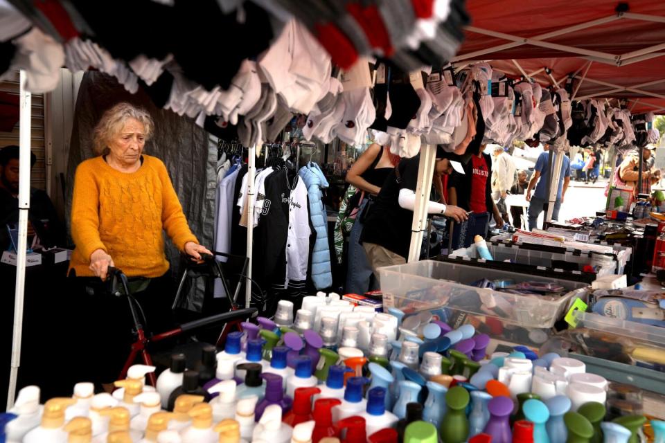 Channah Obadia makes her way along a sidewalk where vendors sell their wares in MacArthur Park