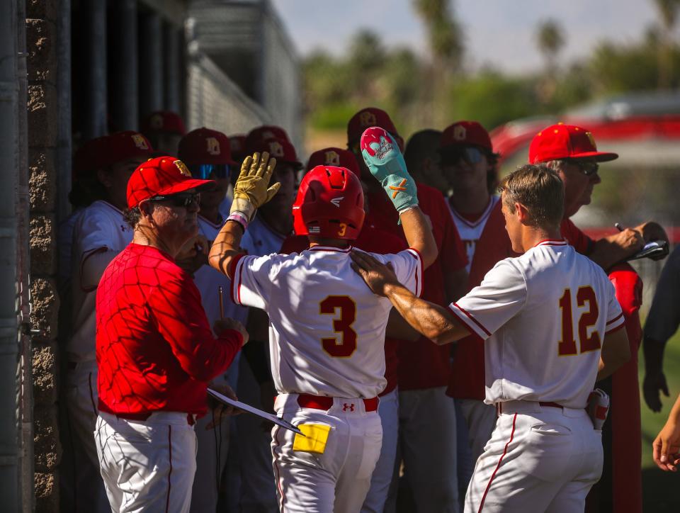 Palm Desert's Stevie Hutchinson (3) celebrates a run with teammates as he returns to the dugout during their second round CIF-SS Division 4 game in Palm Desert, Calif., Tuesday, May 7, 2024.