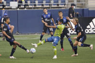 Seattle Sounders forward Raul Ruidiaz (9) kicks the ball between several San Jose Earthquakes during the first half of an MLS soccer match Thursday, Sept. 10, 2020, in Seattle. (AP Photo/Ted S. Warren)