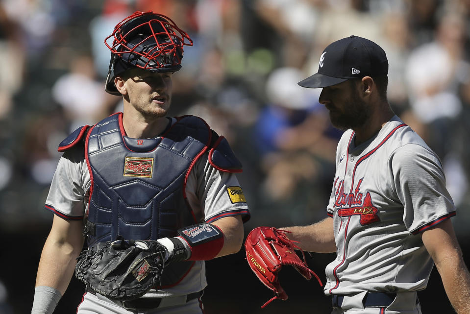 Atlanta Braves' Sean Murphy, left, chats with Chris Sale as they walk back to the dugout at the end of the third inning of a baseball game against the Chicago White Sox, Thursday, June 27, 2024, in Chicago. (AP Photo/Melissa Tamez)