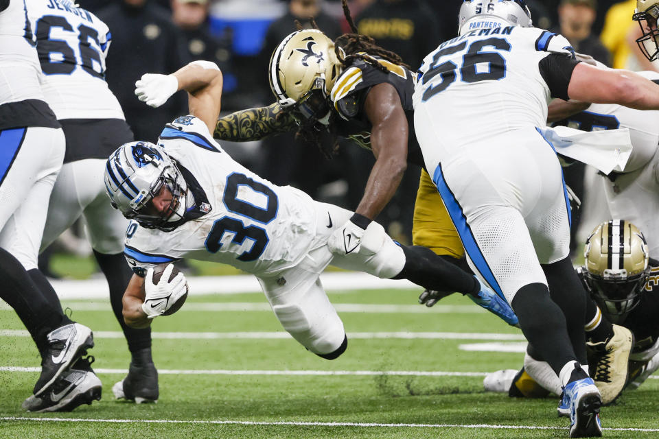 Carolina Panthers running back Chuba Hubbard is tackled by New Orleans Saints linebacker Demario Davis during the second half of an NFL football game in New Orleans, Sunday, Dec. 10, 2023. (AP Photo/Butch Dill)