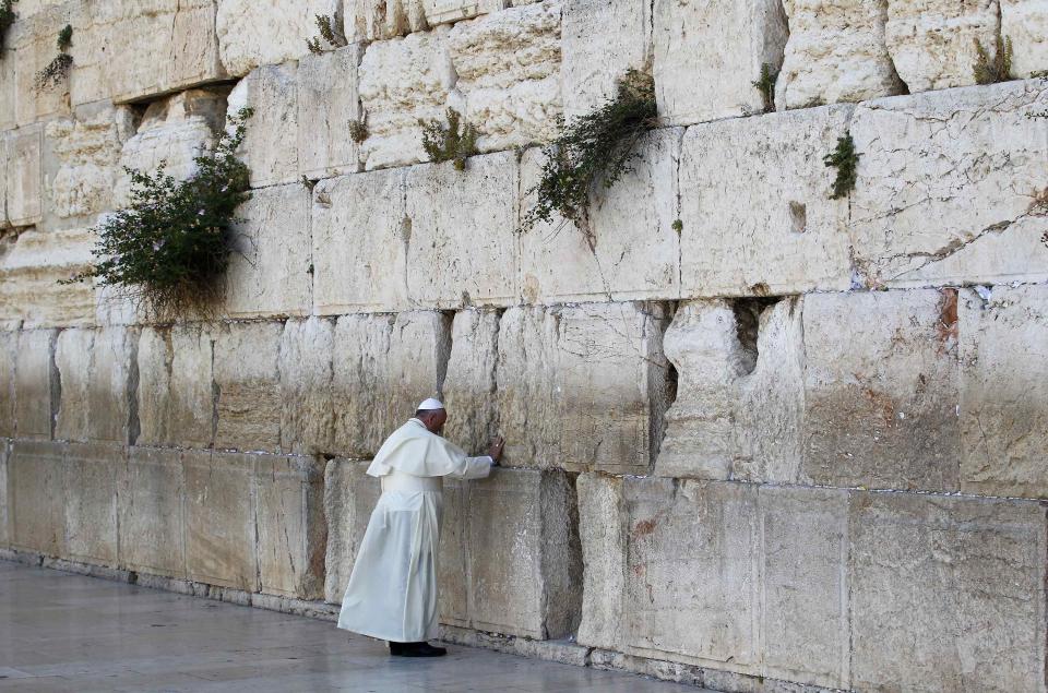 Pope Francis touches the stones of the Western Wall, Judaism's holiest prayer site, in Jerusalem's Old City