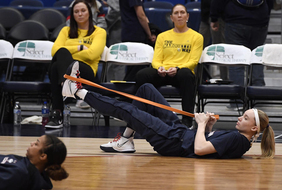 Connecticut's Paige Bueckers warms up with the team before an NCAA college basketball game against Marquette, Wednesday, Feb. 23, 2022, in Hartford, Conn. (AP Photo/Jessica Hill)