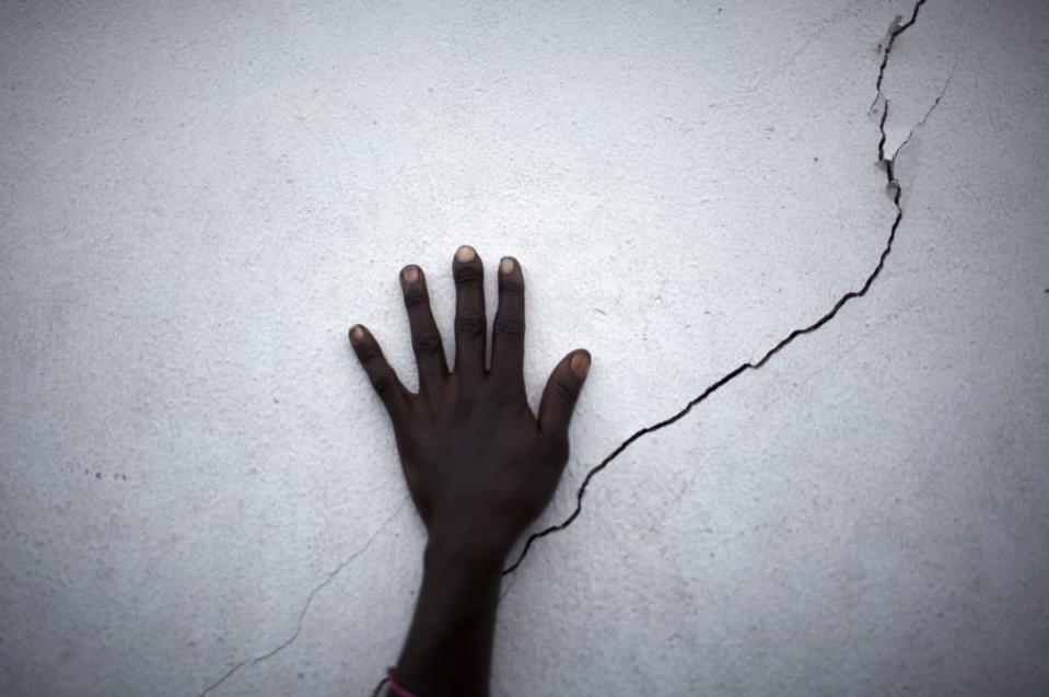 <div class="inline-image__caption"><p>A woman puts her hand near a crack on a wall as she waits for food distribution in Port-au-Prince, Haiti January 27, 2010. A shallow 4.9 magnitude aftershock rattled western Haiti on Tuesday, two weeks after a killer 7.0 magnitude earthquake devastated the Haitian capital, Port-au-Prince, the U.S. Geological Service said.</p></div> <div class="inline-image__credit">Carlos Barria/Reuters</div>