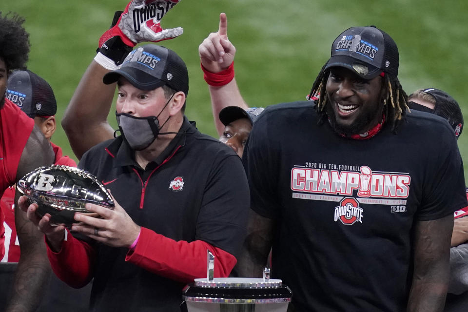 Ohio State head coach Ryan Day, left, holds the trophy along side running back Trey Sermon after defeating Northwestern in the Big Ten championship NCAA college football game, Saturday, Dec. 19, 2020, in Indianapolis. Ohio State won 22-10. (AP Photo/Darron Cummings)