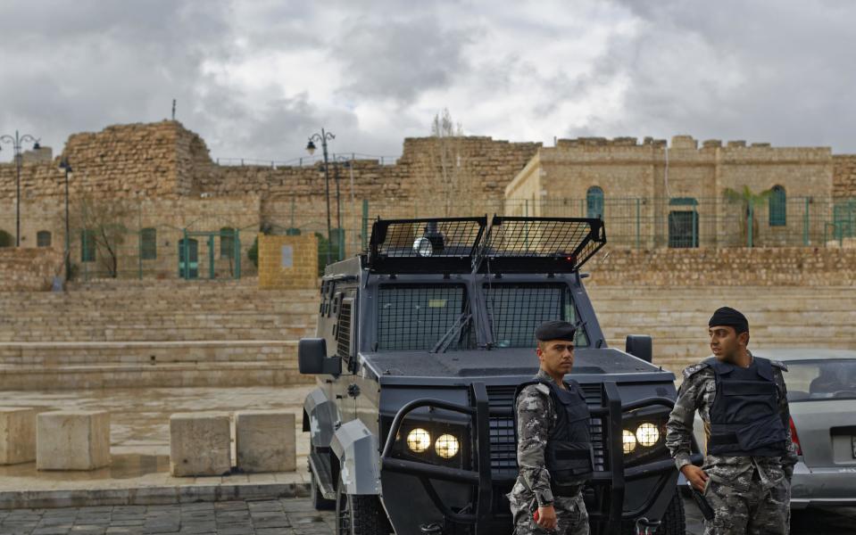 Jordanian security forces and their armored vehicles stand guard in front of Karak Castle in the central town of Karak, about 140 kilometers (87 miles) south of the capital Amman, in Jordan on Monday, Dec. 19, 2016. Gunmen assaulted Jordanian police in a series of attacks Sunday, including at the Karak Crusader castle popular with tourists, officials said. (AP Photo/Ben Curtis)