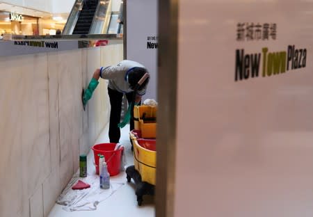 Workers clean graffiti at New Town Plaza in Sha Tin, Hong Kong, China