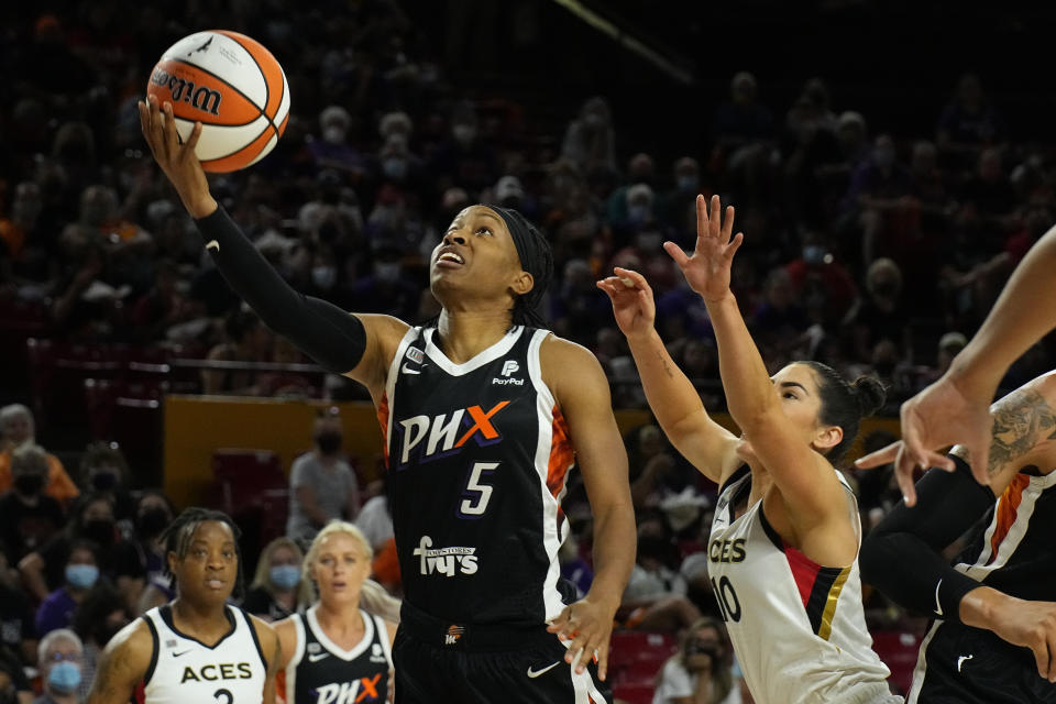 Phoenix Mercury guard Shey Peddy (5) drives past Las Vegas Aces guard Kelsey Plum (10) during the first half of a WNBA basketball game Sunday, Oct. 3, 2021, in Phoenix. (AP Photo/Rick Scuteri)