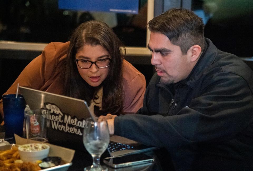 County supervisor District 1 candidate Lilliana Udang, left, checks out election results on a laptop computer with San Joaquin County Democratic Central Committee chair Manuel Zapata at Jerry McNerney's election watch party at Valley brew in Stockton for the 2024 California Primary Election on Mar. 5, 2024.