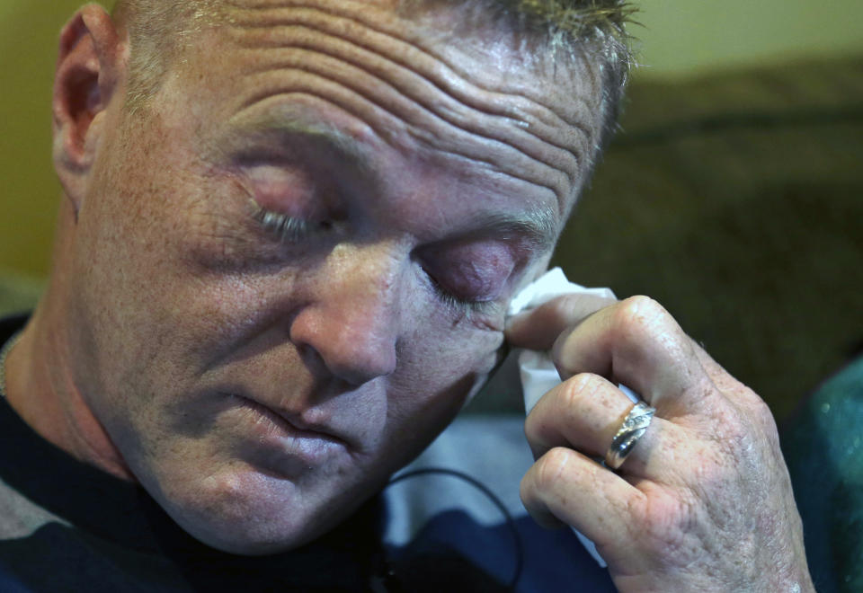 In this Friday, Jan. 10, 2014 photo, Kainan McAllister, brother of Denise Freeman, wipes away tears during an interview with The Associated Press in Chalmette, La. Denise was the first victim in the killing spree at the hands of her husband, Benjamin Freeman. The shootings stunned the bayou community 50 miles southwest of New Orleans. Investigators, victims and grieving family members don’t know exactly what set off Freeman’s rampage. But the shootings raised concerns about whether Louisiana law provides adequate safeguards to keep guns away from troubled people. (AP Photo/Gerald Herbert)