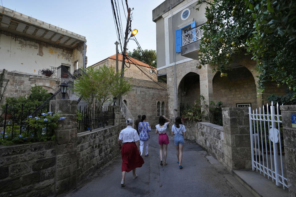 Tourists visit Batroun village, north of Beirut, Lebanon, Friday, July 2, 2021. With their dollars trapped in the bank, a lack of functioning credit cards and travel restrictions imposed because of the pandemic, many Lebanese who traditionally vacationed over the summer at regional hotspots are also now turning toward domestic tourism. (AP Photo/Hassan Ammar)