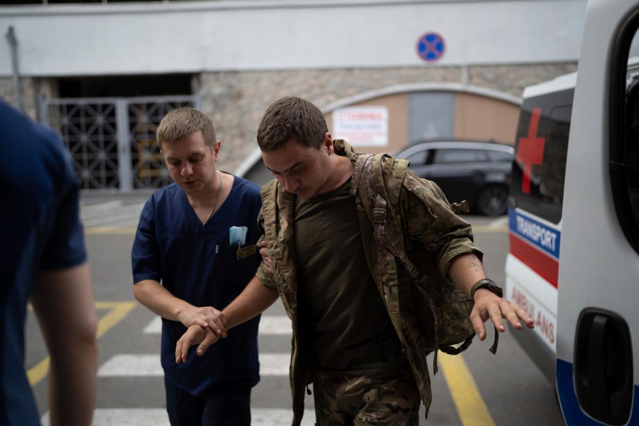 Medics help a shell-shocked Ukrainian serviceman enter Mechnikov Hospital in Dnipro, Ukraine, last week (AP)