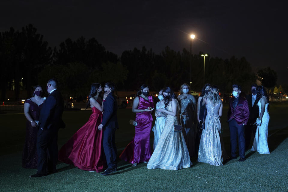 Young people attend prom at the Grace Gardens Event Center in El Paso, Texas on Friday, May 7, 2021. Around 2,000 attended the outdoor event at the private venue after local school districts announced they would not host proms this year. Tickets cost $45. (AP Photo/Paul Ratje)