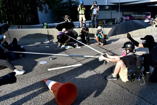 A protester prepares to launch bricks at the police using an improvised slingshot in Hong Kong's central Admiralty area