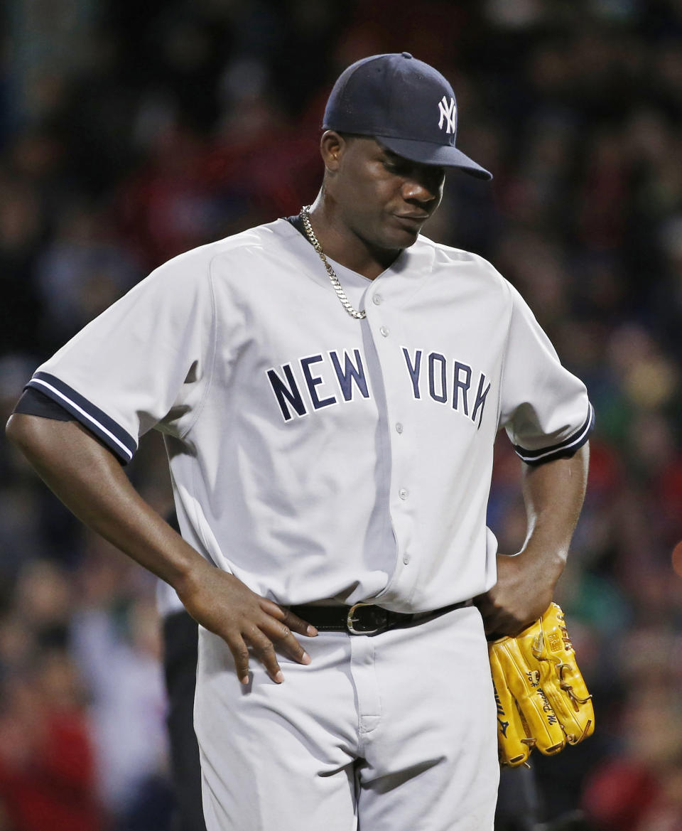 New York Yankees starting pitcher Michael Pineda walks off the mound after being ejected when a foreign substance was discovered on his neck, in the second inning of a baseball game against the Boston Red Sox at Fenway Park in Boston, Wednesday, April 23, 2014. (AP Photo/Elise Amendola)