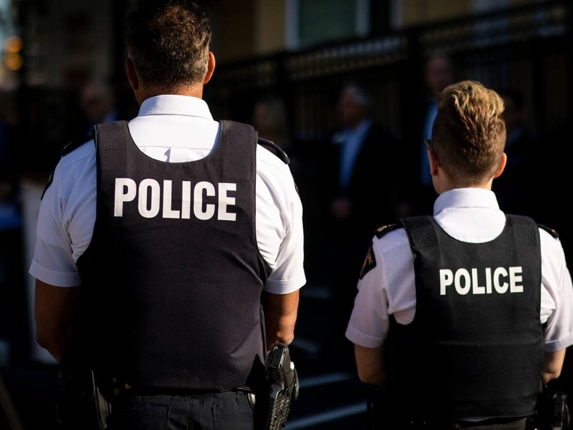 Two RCMP officers are pictured in Richmond, British Columbia, on Tuesday, September 20, 2022.  (Ben Nelms/CBC - image credit)