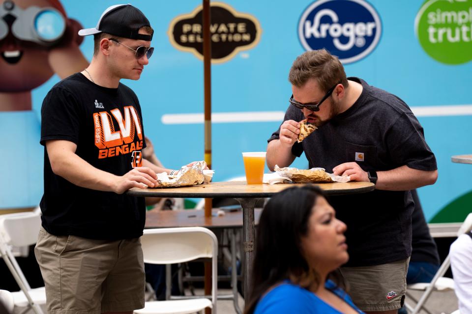 Ryan Beard, left, and Jackson Kirk eat Gyros from Chicago Gyros at Taste of Cincinnati 2023.