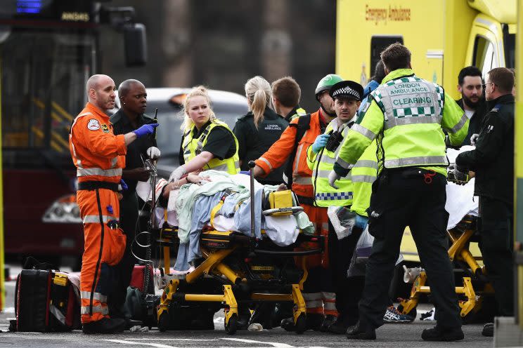 A member of the public being treated by emergency services near Westminster Bridge and the Houses of Parliament on 22 March 2017 in London. [Photo by Carl Court | Getty Images]