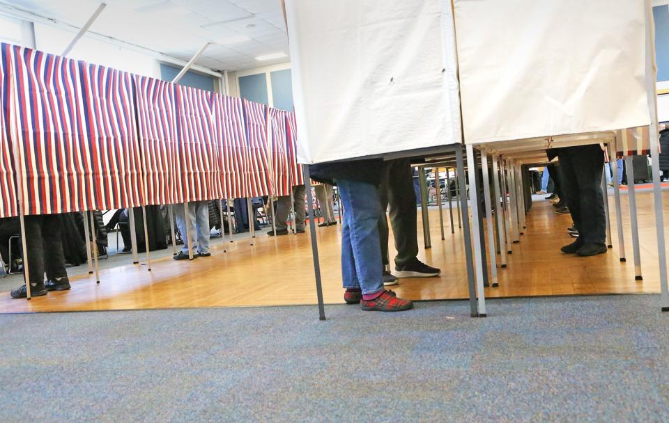 Hampton residents cast their votes on local issues and elections at Winnacunnet High School on March 12, 2024.