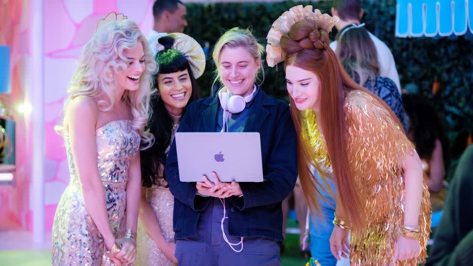 Director Greta Gerwig works alongside Margot Robbie and fellow actresses on set of "Barbie." - Jaap Buitendijk/Warner Bros. Entertainment Inc