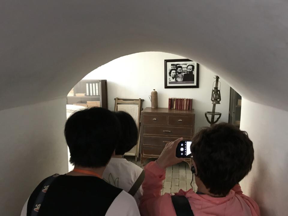 Tourists visit a cave where Mao Zedong once lived in the 1940s.