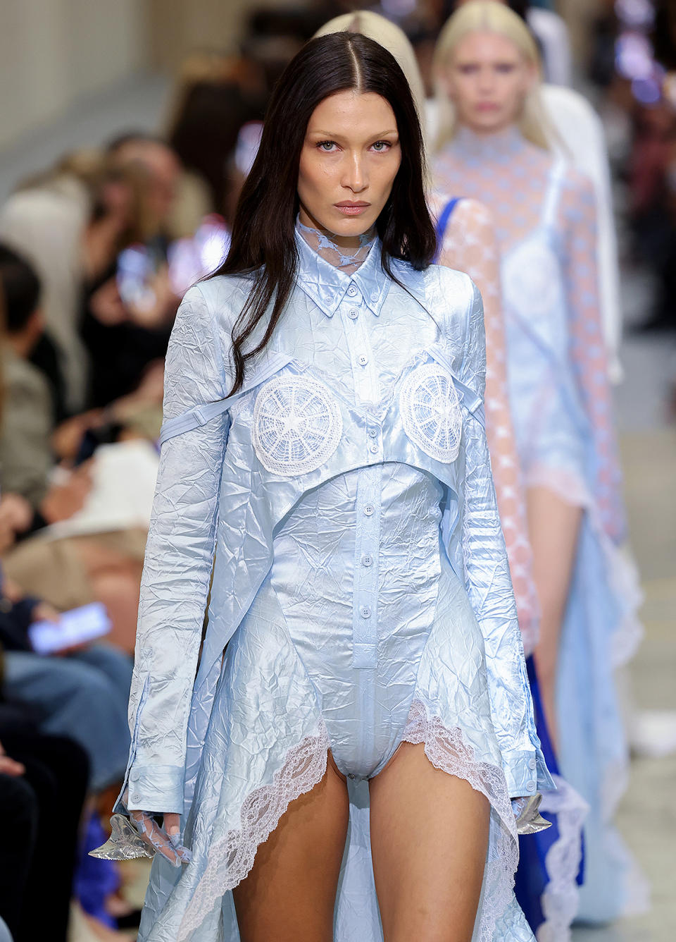 <p>The model walks the Burberry runway wearing a light blue lacy look.</p>