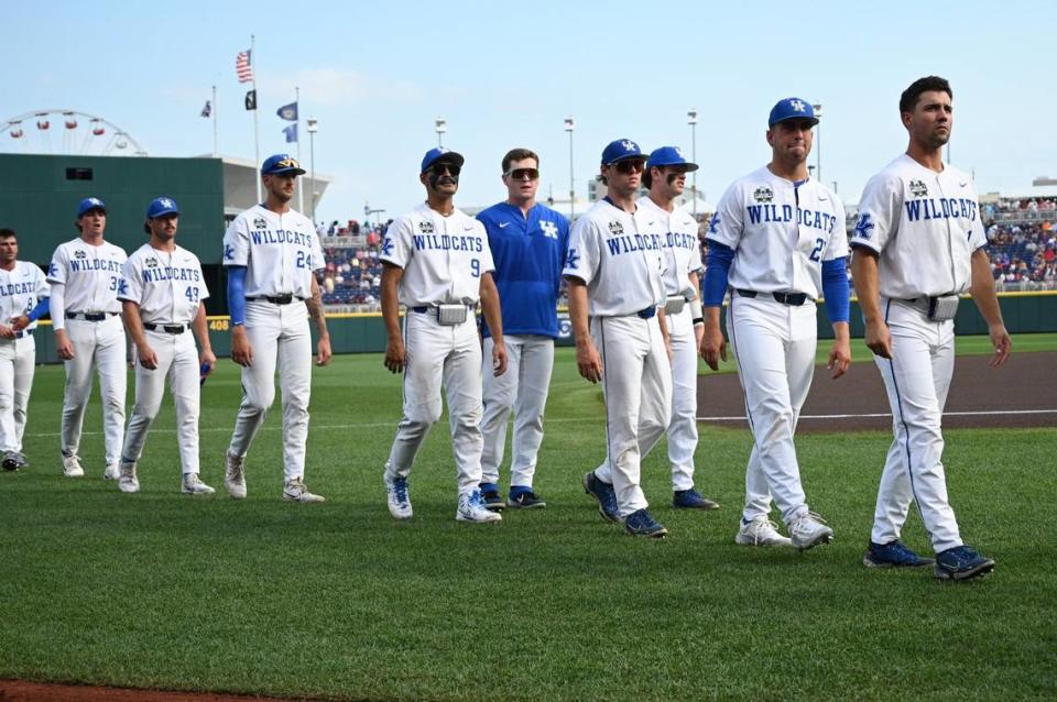 The Kentucky Wildcats head to the dugout before their game Monday against Texas A&M at Charles Schwab Field in Omaha, Nebraska.