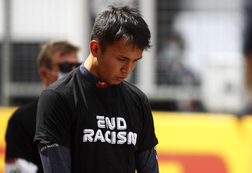 Red Bull driver Alexander Albon of Thailand stands against racism in the pit lane prior the Styrian Formula One Grand Prix race at the Red Bull Ring racetrack in Spielberg, Austria, Sunday, July 12, 2020. (Mark Thompson/Pool via AP)