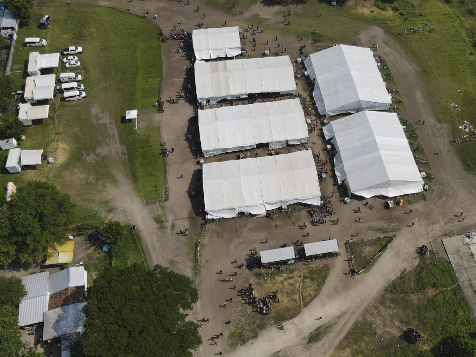 Migrants, mostly from Venezuela, arrive at a camp where Mexican authorities will arrange permits for their continued travel north, in San Pedro Tapanatepec, Oaxaca, Mexico Wednesday, Oct. 5, 2022. As migrants, especially Venezuelans, struggle to come to terms with a new U.S. policy discouraging border crossings, the town of San Pedro Tapanatepec is unexpectedly playing host to over 10,000 migrants camped far from the U.S. border. (AP Photo/Marco Ugarte)