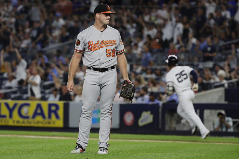 Baltimore Orioles' Evan Phillips (58) reacts as New York Yankees' Gleyber Torres (25) runs the bases after hitting a three-run home run during the fifth inning of the second game of a baseball doubleheader Monday, Aug. 12, 2019, in New York. (AP Photo/Frank Franklin II)