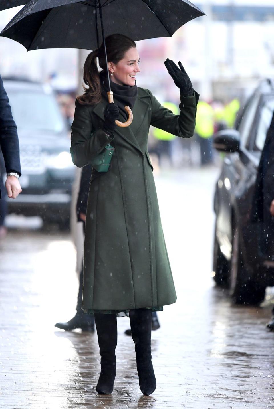 <p>Here she is waving to the crowds. For the day of engagements, the Duchess wore a coat by Sportmax and Michael Kors dress. <a rel="nofollow noopener" href="https://www.townandcountrymag.com/style/fashion-trends/a26677256/kate-middleton-green-michael-kors-dress-blackpool/" target="_blank" data-ylk="slk:Get all the details on her outfit here.;elm:context_link;itc:0;sec:content-canvas" class="link ">Get all the details on her outfit here.</a></p>