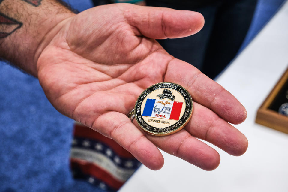 Michael Braman shows off his challenge coin at the VFW Convention in Kansas City, Mo., on July 16, 2022. (Dominick Williams for NBC News)