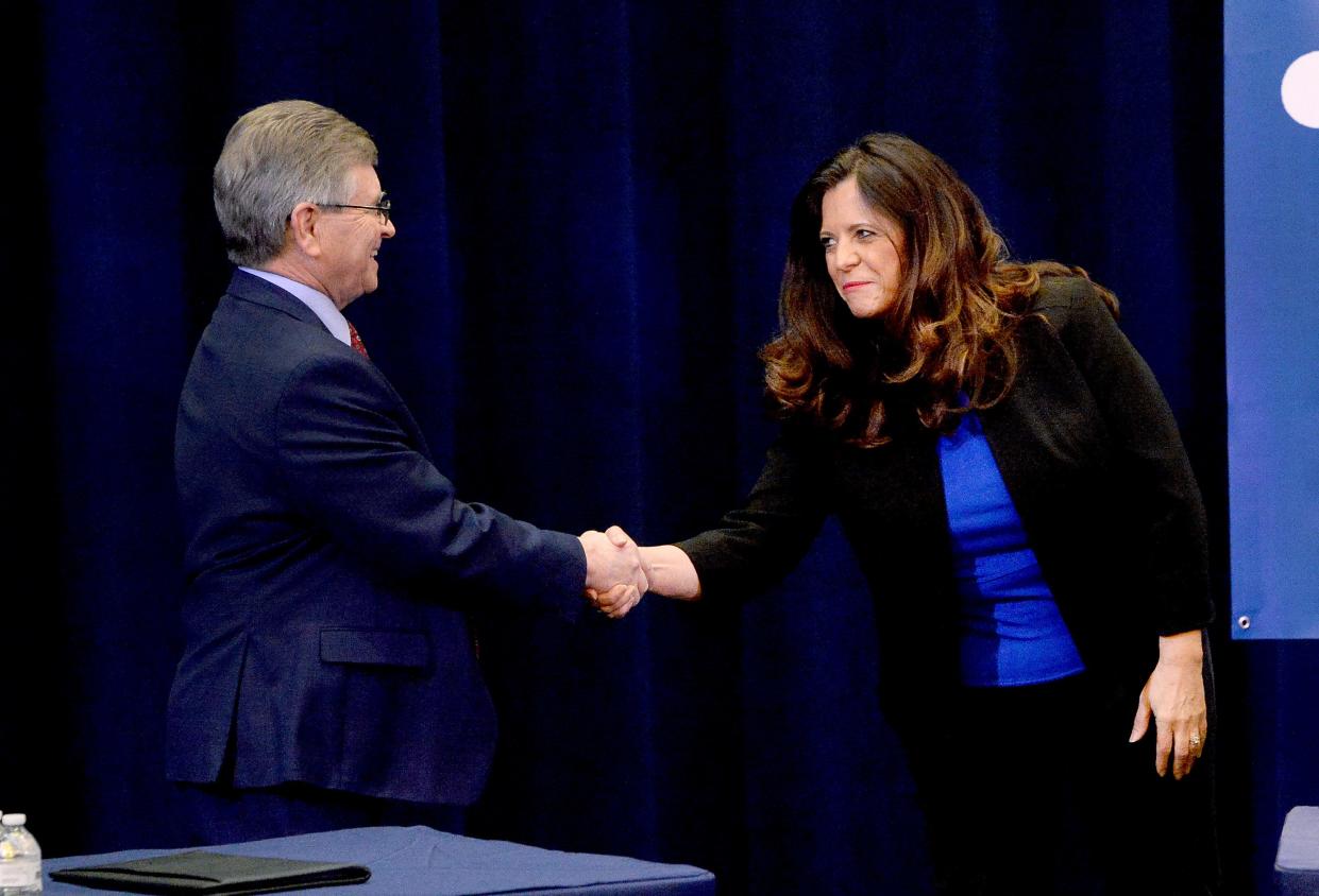 Mayor, Incumbent Jim Langfelder, left, shakes hand with treasurer and candidate for mayor Misty Buscher before debating at the Hoogland Center for the Arts Wednesday Jan. 25, 2023.