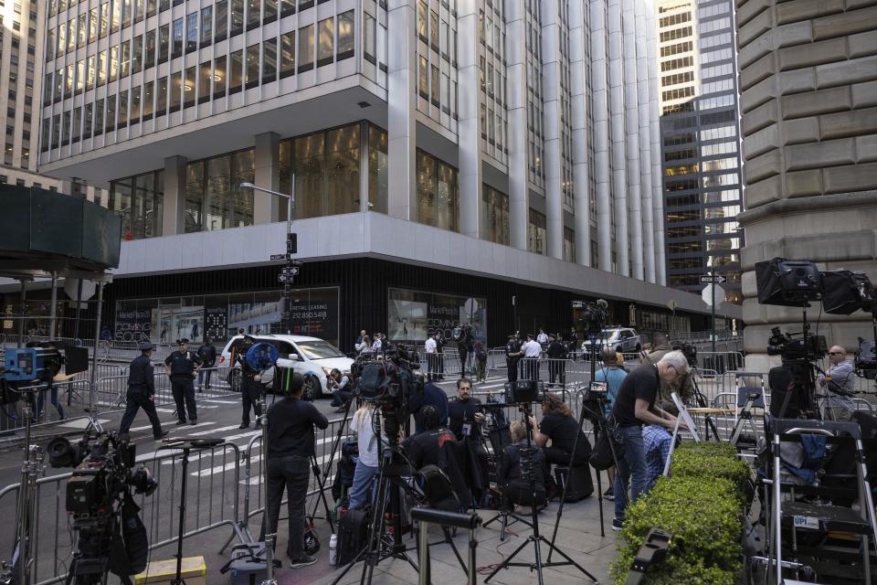 Members of the media gather outside an Attorney General's office building for depositions in a civil investigation in New York, Thursday, April. 13, 2023. Former President Donald Trump is expected to visit the offices of New York’s attorney general for his second deposition in a legal battle over his company’s business practices. (AP Photo/Yuki Iwamura)