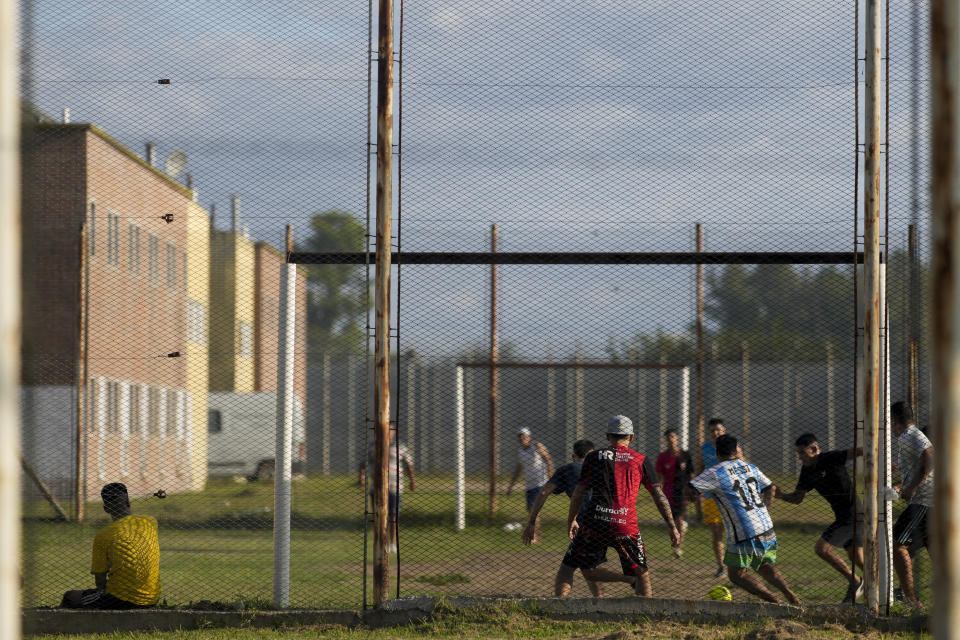 Inmates play soccer at Pinero jail in Pinero, Argentina, Tuesday, April 9, 2024. Authorities have ramped up prison raids, seized thousands of smuggled cellphones and restricted visits. (AP Photo/Natacha Pisarenko)