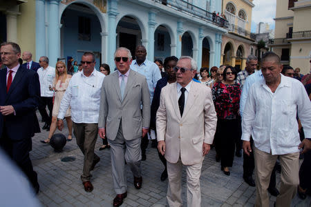 Britain's Prince Charles walks with Eusebio Leal, the official historian of Havana in Old Havana, Cuba March 25, 2019. REUTERS/Alexandre Meneghini