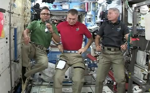 Joe Acaba, left, the first astronaut of Puerto Rican heritage, talks during an interview with The Associated Press alongside Italy's Paolo Nespoli, center, and Mark Vande Hei from the International Space Station - Credit: NASA/AP