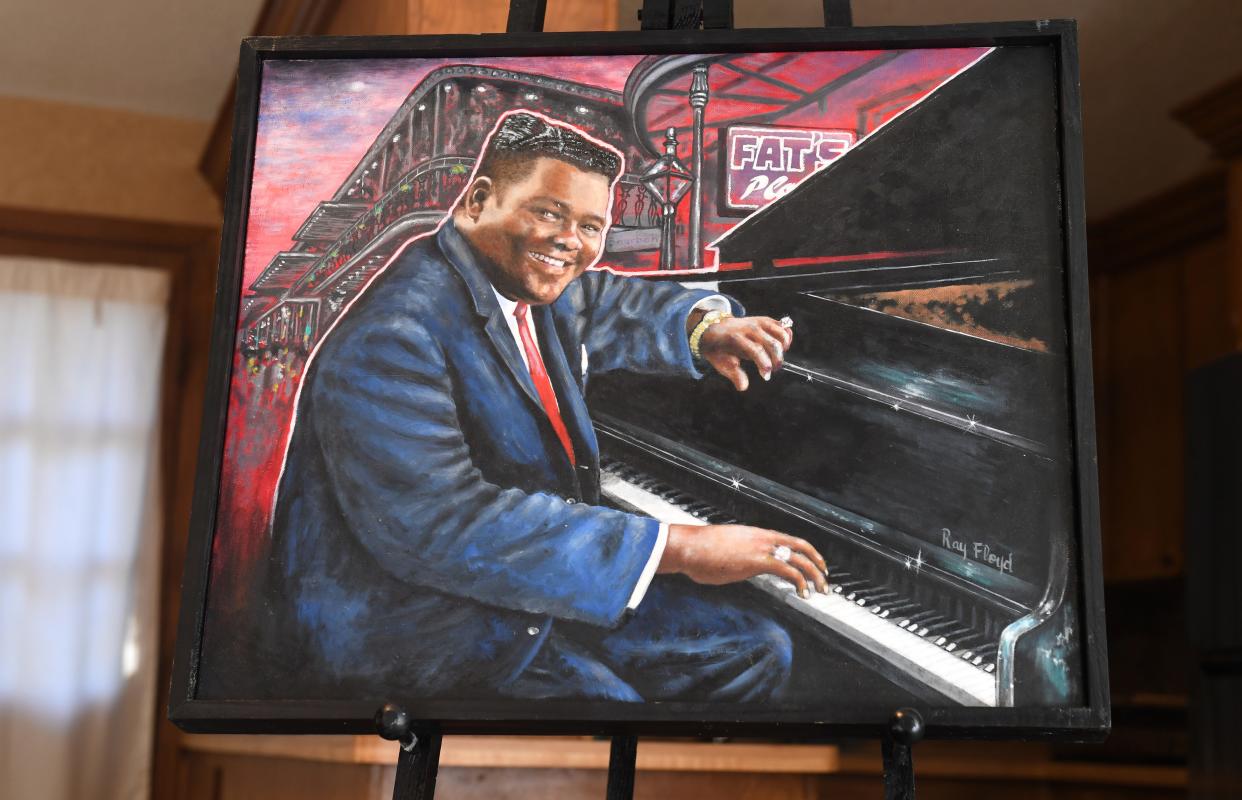 Raymond Floyd was a Spartanburg artist and art teacher. He was the first Black art educator in Spartanburg District 7. He passed away Nov. 21 at 82. Heather Mitchell shows off one of her father's paintings of famous people, this one is of Fats Domino.