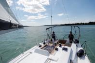 Members of a boat rental agency ride a sailing boat on Lake Balaton, following the outbreak of the coronavirus disease (COVID-19), near Balatonfured