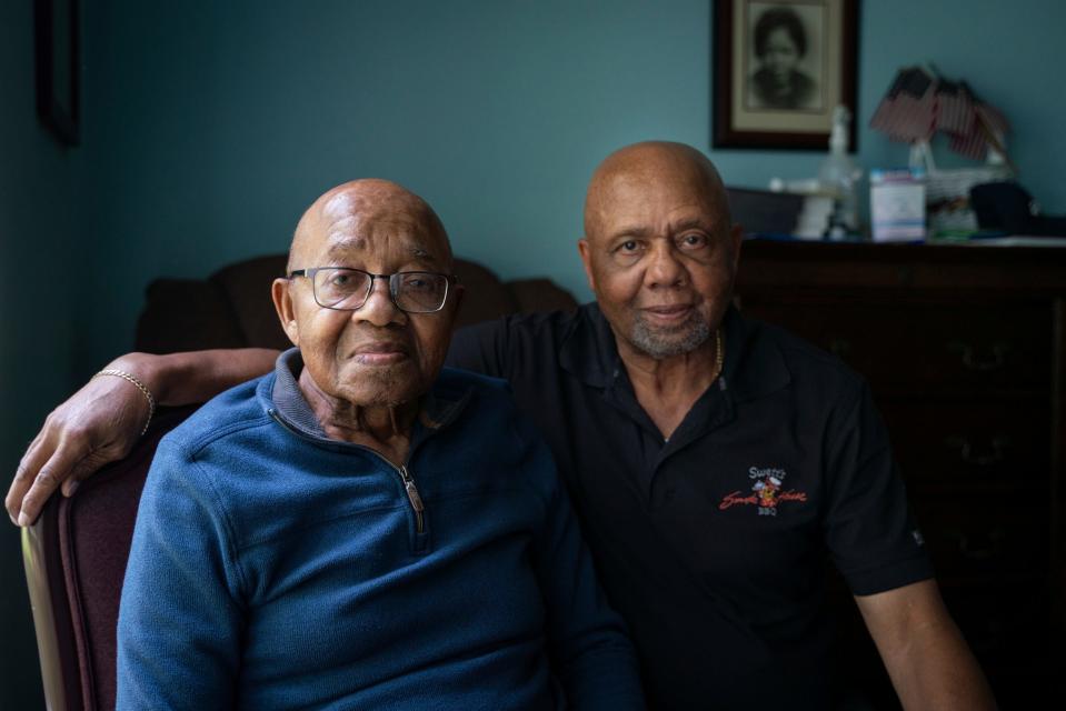 William Henry Micou, left, a military veteran and Red Ball Express driver during World War II, and his son Herb Micou, 76, pose together for a photo days before Micou's 99th birthday at American House Senior Living in Farmington Hills on Monday, August 21, 2023.