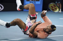 Australia's Nick Kyrgios falls while making a return to Russia's Karen Khachanov during their third round singles match at the Australian Open tennis championship in Melbourne, Australia, Saturday, Jan. 25, 2020. (AP Photo/Lee Jin-man)