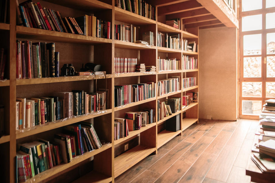 Several books on wooden shelves in a library