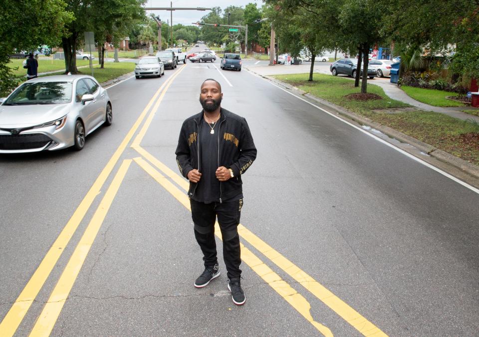 Durrell Palmer stands June 23, 2020, along North A Street between West Cervantes and West Gadsden streets in Pensacola, where he and others painted a Black Lives Matter mural.