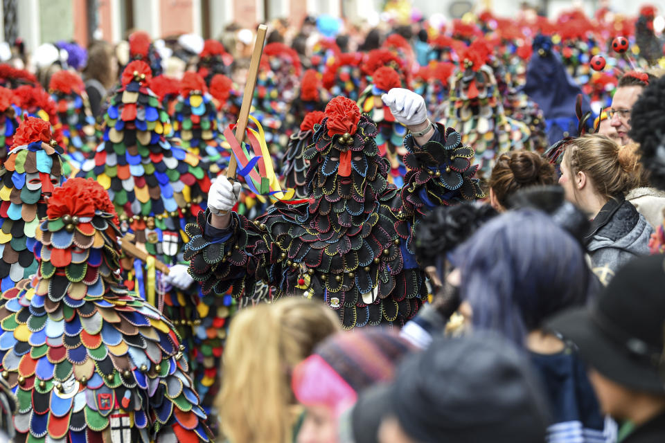 A group of fools attend a parade during the great fool's leap through the city centre of Konstanz, Germany, Sunday, Feb. 23, 2020. (Felix Kaestle/dpa via AP)